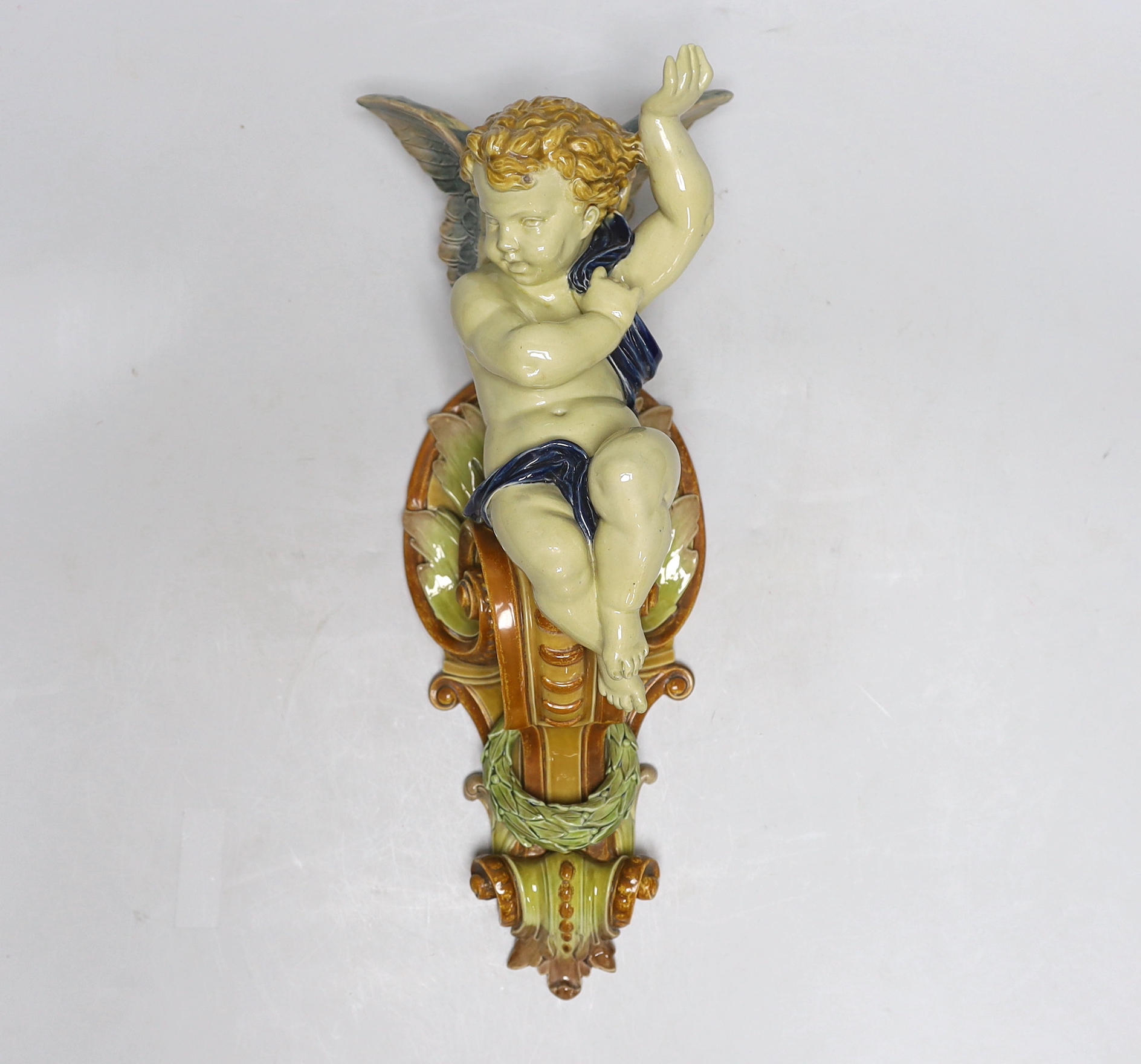 Hughes Protat, a Minton Majolica cherubic wall bracket, incised signature, 42cm high